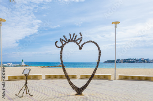 Iron sculpture in the shape of a heart in Palmanova Beach (Calvia, Mallorca) empty without people. Tourist destination in the Mediterranean