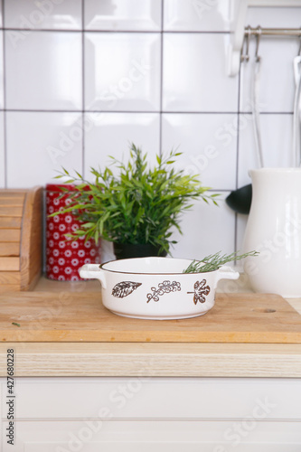 White empty ceramic baking dish in a light scandinavian kitchen