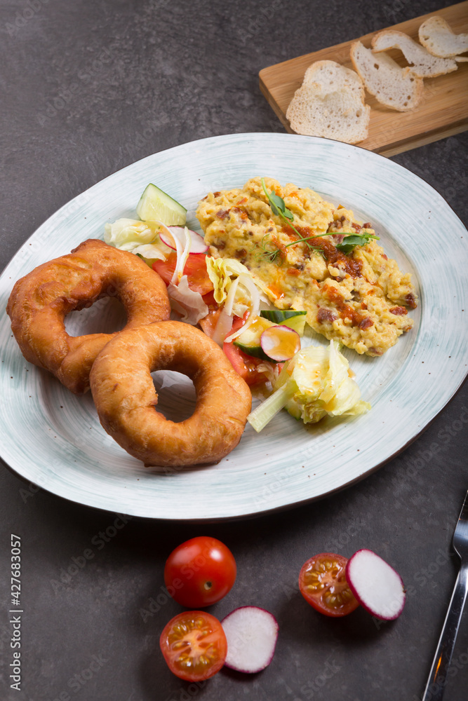 Donuts and egg served for breakfast on a table Donuts and egg served for breakfast on a table