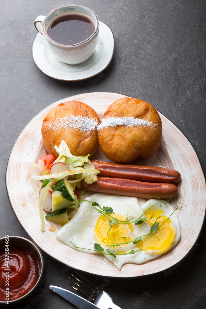 Berliner donuts served with sausage and fried eggs Berliner donuts served with sausage and fried eggs