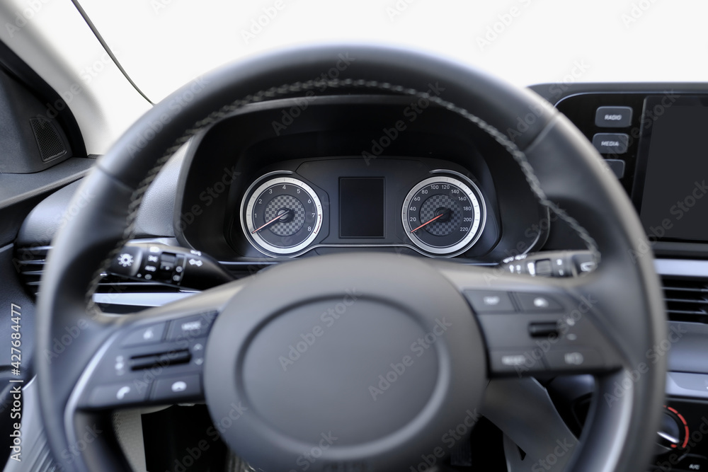 Speedometer, rev counter and steering wheel of a car
