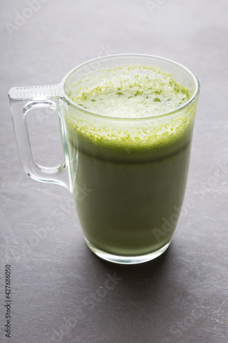 Glass cup of green matcha latte coffee