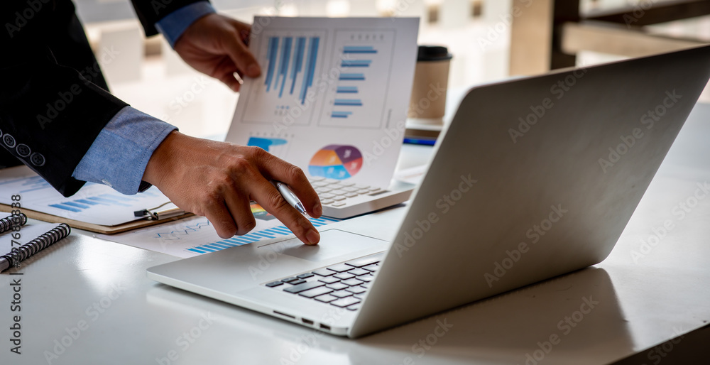 Financial Business man analyze the graph of the company's performance to create profits and growth, Market research reports and income statistics, data,repotr,Financial and Accounting concept. Financial Business man analyze the graph of the company's performance to create profits and growth, Market research reports and income statistics, data,repotr,Financial and Accounting concept.