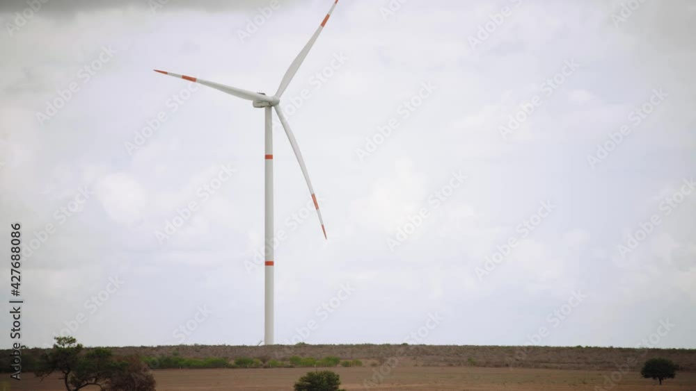 Clouds, the horizon, and a wind turbine in a wind energy farm, Mexico, wide shot Clouds, the horizon, and a wind turbine in a wind energy farm, Mexico, wide shot