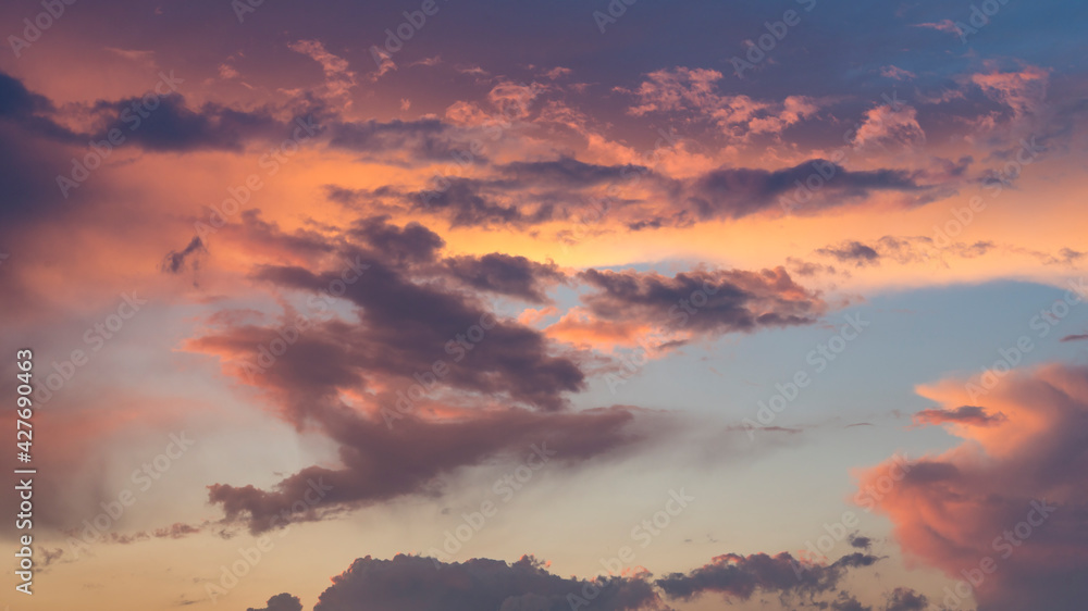 Fototapeta premium Panoramic view of dramatic clouds during sunset. The dynamic sky before a storm