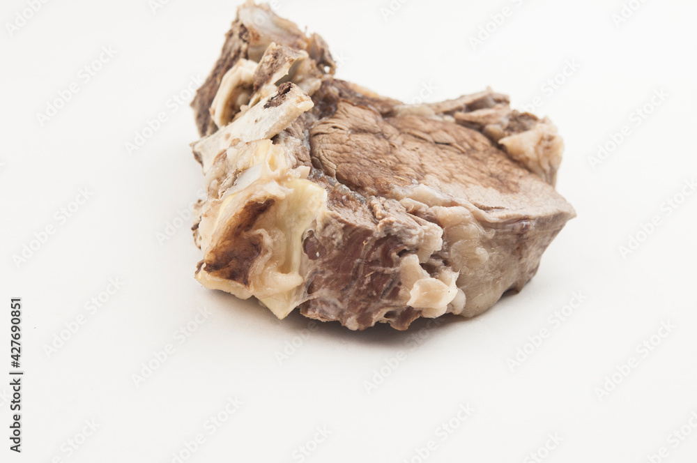 Piece of boiled beef with bone on white background Piece of boiled beef with bone on white background