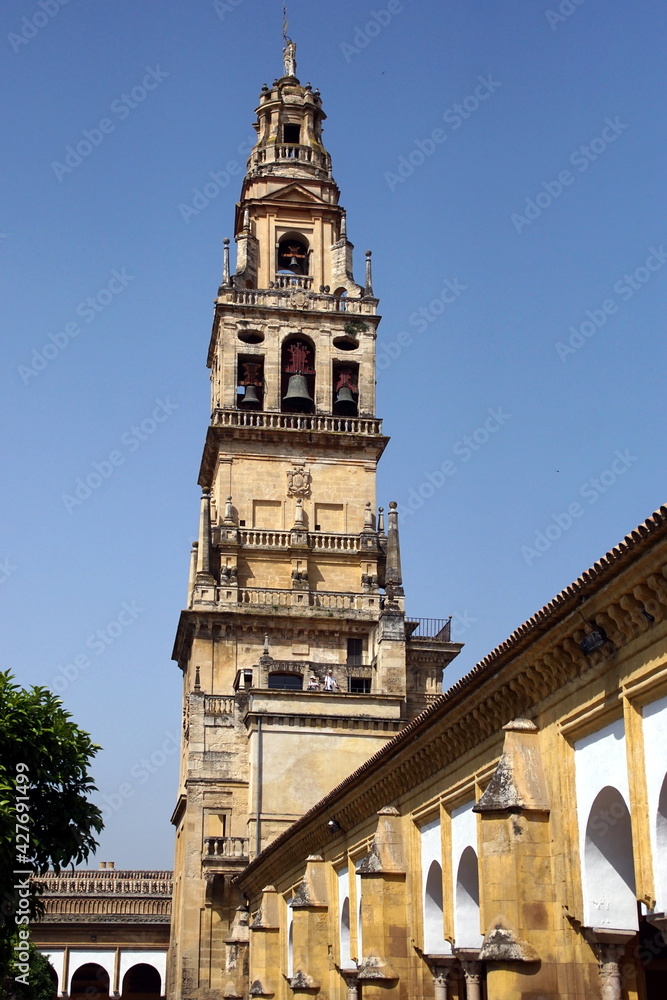 Bell tower of Mezquita, Mosque-Cathedral against clear blue sky, Cordoba. Andalusia, Spain.