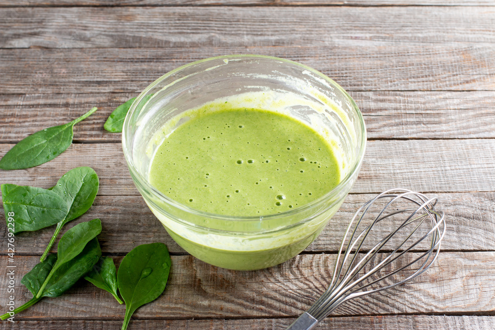 Raw ingredients for cooking healthy spinach pancakes on table. Gluten free spinach pancakes recipe Raw ingredients for cooking healthy spinach pancakes on table. Gluten free spinach pancakes recipe