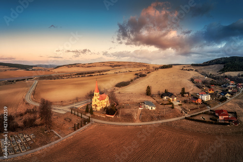 church in the village of Cencice at sunset