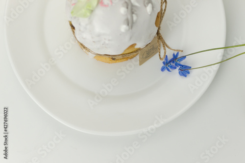 Orthodox cake on a plate with a blue flower top view on a white background