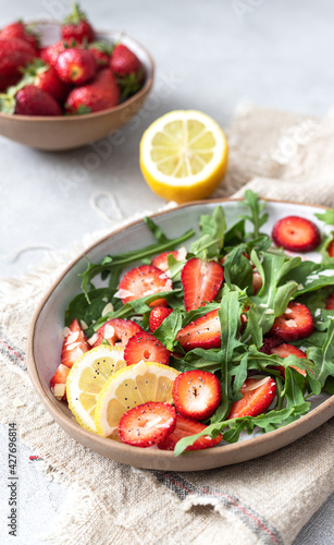 Healthy organic diet salad with arugula, strawberries and almonds. 