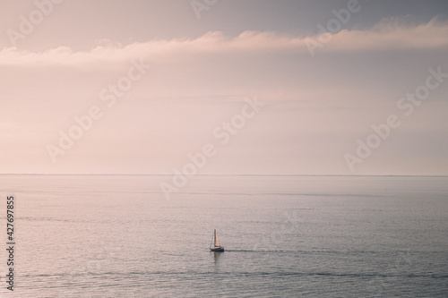 Dreamy boat on the ocean sailing in the sunset. Dreamy sunset background image © Saa