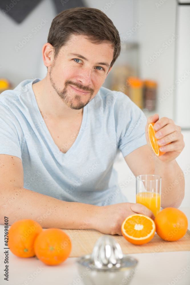 cropped view of woman preparing tasty orange juice in kitchen cropped view of woman preparing tasty orange juice in kitchen