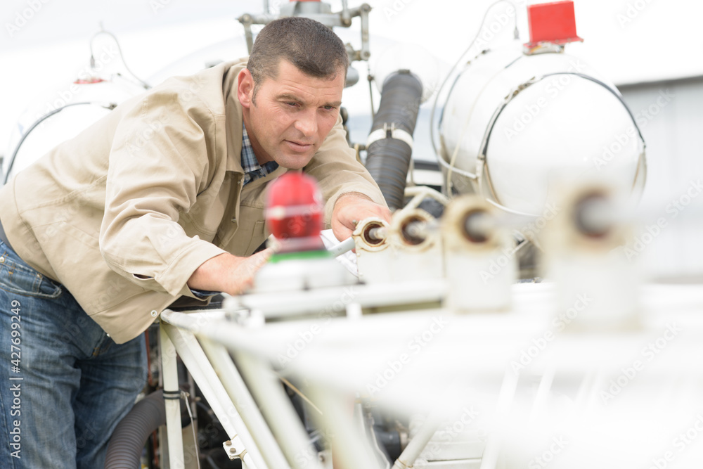 a mechanic is fixing something a mechanic is fixing something