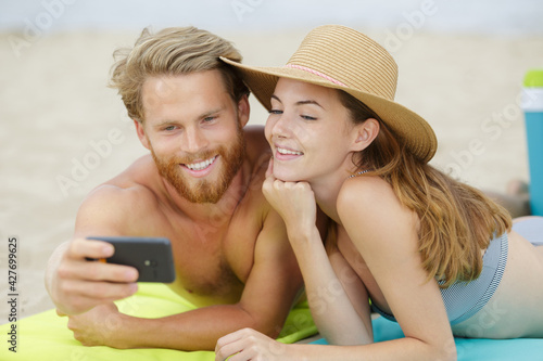 couple taking selfie photo at the beach © auremar