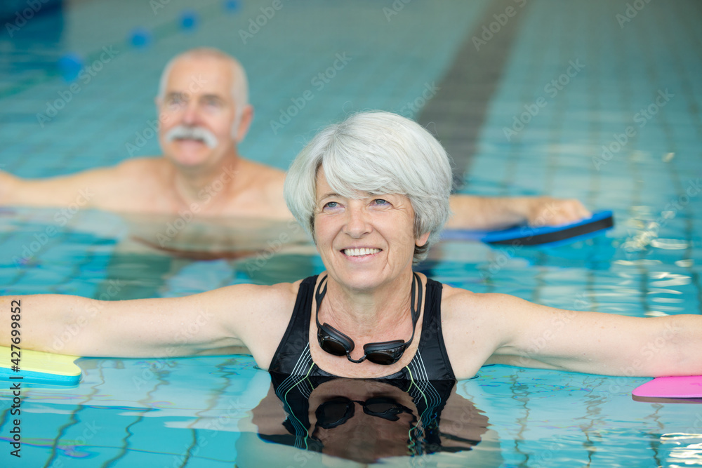 two elderly people having water exercise
