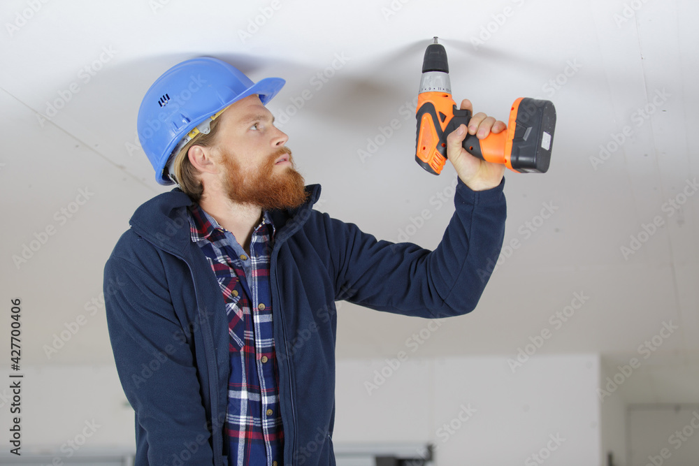man is drilling the ceiling man is drilling the ceiling
