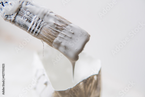a brush from which white paint flows down