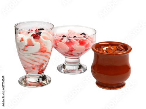 Set of ice cream of different colors and flavors with berries and nuts decoration
