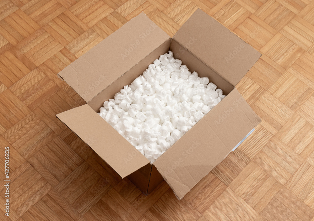 A cardboard box with packing styro foam pellets top view A cardboard box with packing styro foam pellets top view