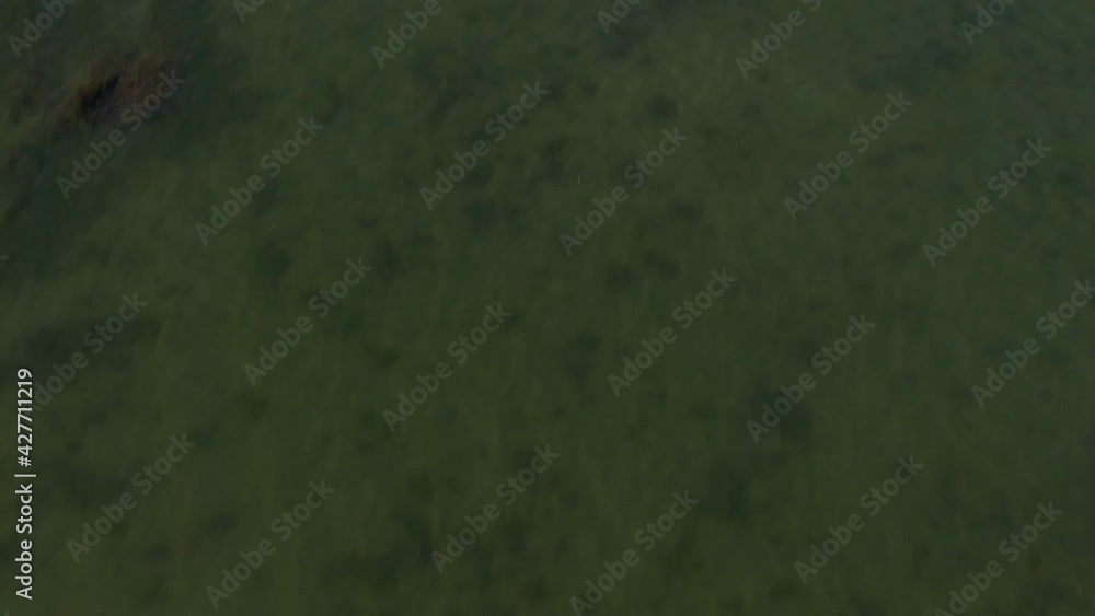 Water tilt-up aerial view and reveal of majestic coastal pier in Sweden Water tilt-up aerial view and reveal of majestic coastal pier in Sweden