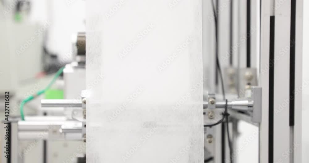 Polypropylene Non-Woven Fabric For Medical Mask At Production Line - Protection For Corona Virus - Closeup, Slow Motion Polypropylene Non-Woven Fabric For Medical Mask At Production Line - Protection For Corona Virus - Closeup, Slow Motion