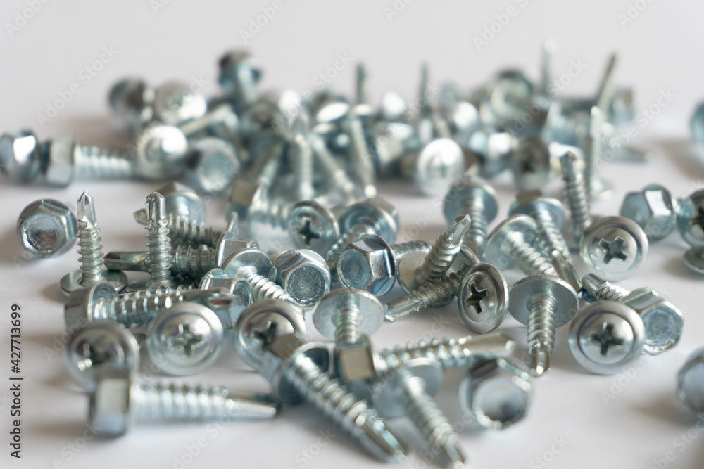 screws piled up on a white background. Construction concept screws piled up on a white background. Construction concept