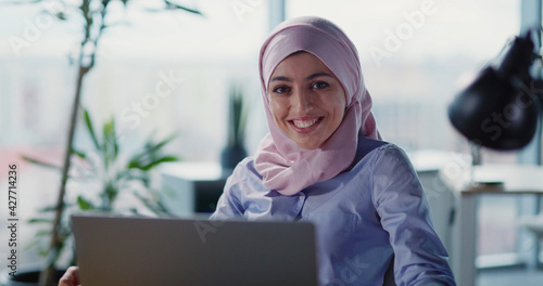 Photography Attractive young arabic woman using laptop computer in the corporate office
