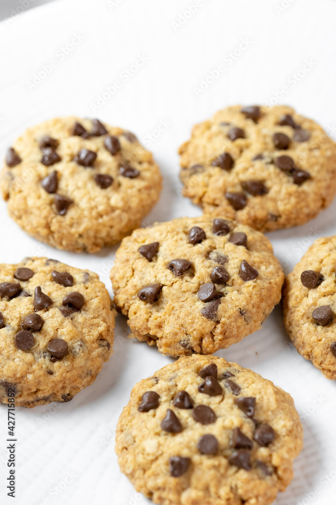Delicious Whole Wheat Chocolate Chip Cookies set on white cafe table. Delicious Whole Wheat Chocolate Chip Cookies set on white cafe table.