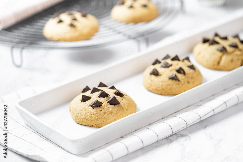 Delicious Whole Wheat Chocolate Chip Cookies set on white cafe table. Delicious Whole Wheat Chocolate Chip Cookies set on white cafe table.