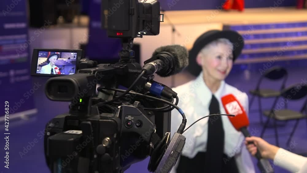 Television camera broadcast interview with business woman speaker in conference hall room Spbd Television camera broadcast interview with business woman speaker in conference hall room Spbd