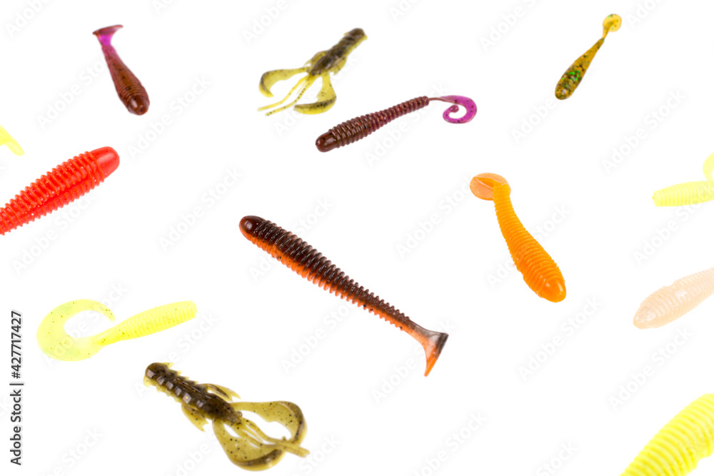 Multicolored silicone baits isolated on white background. Studio photo. Multicolored silicone baits isolated on white background. Studio photo.