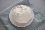 Large meringue on a plate and a blue napkin