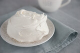 Large meringue on a plate and a blue napkin