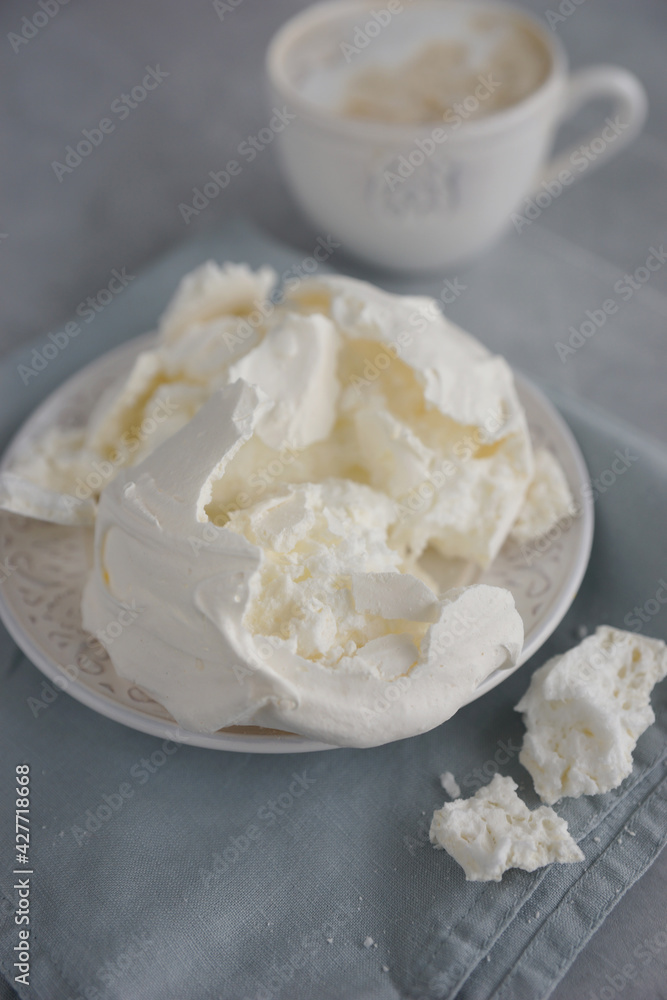 Large meringue on a plate and a blue napkin Large meringue on a plate and a blue napkin