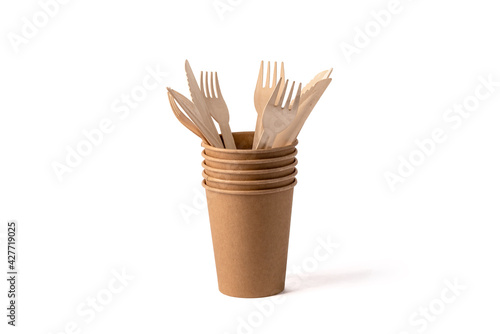 Disposable wooden cups for coffee and tea. Cutlery in a cup.