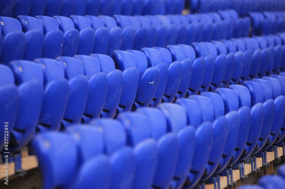 Fototapeta premium The empty blue plastic seat at stadium.