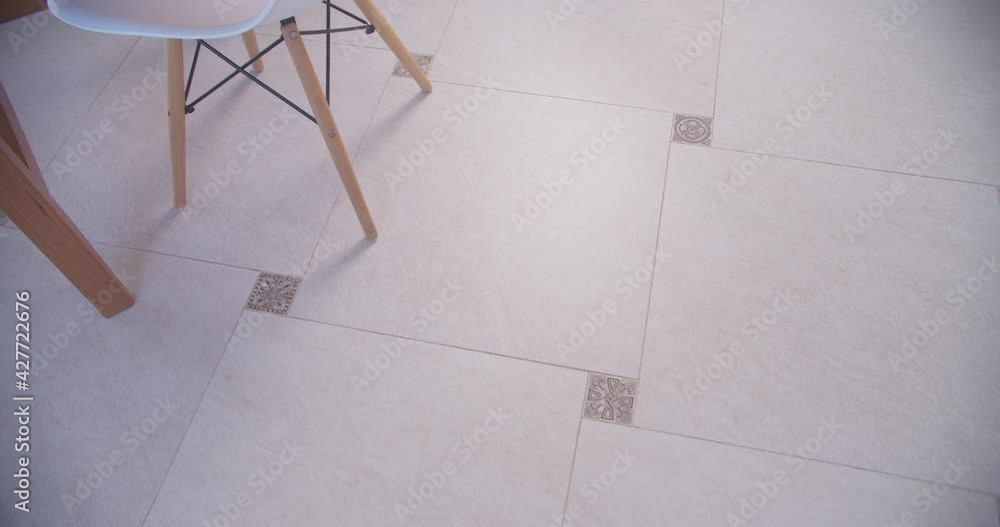 Cleaning modern wooden floor from shreds of hair, dust and dirt with soft mop during tidying up side view Cleaning modern wooden floor from shreds of hair, dust and dirt with soft mop during tidying up side view