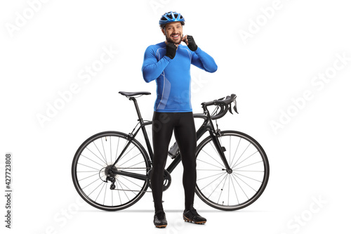Male cyclist putting on a helmet and smiling next to his bicyclE