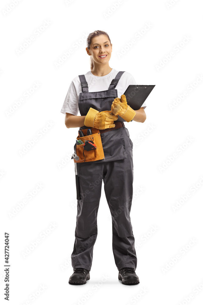 Full length portrait of a young repairwoman with a tool belt holding a clipboard Full length portrait of a young repairwoman with a tool belt holding a clipboard