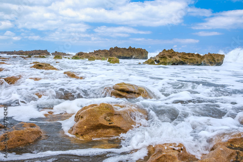 Waves crashing on the rocks on the beach at the Blowing Rock Preserve in Florida.