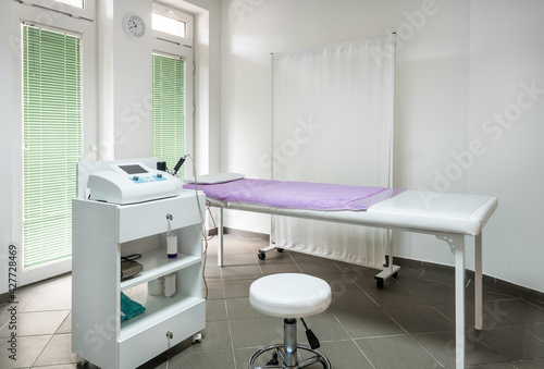 Physician Doctors Office with examination bed and therapy equipment © Ivan