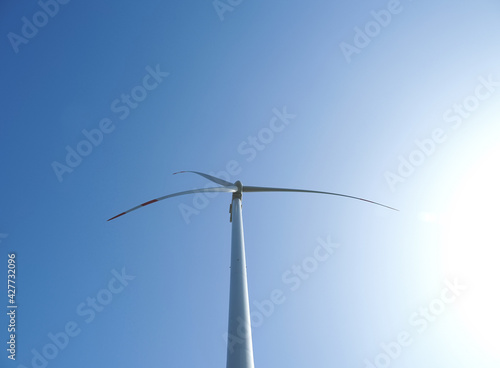 Windmill against blue sky in sunshine © wlad074