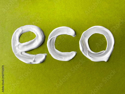 Concept of zero waste, natural cosmetics.ECO cream lettering. White letters on green craft eco background. Flat lay.
