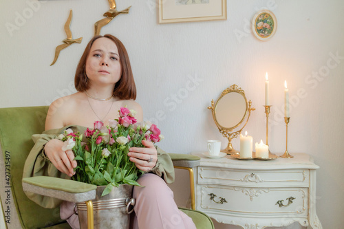 woman with a bouquet of flowers in a beautiful room