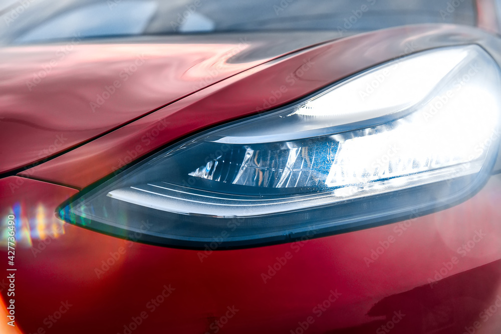 Front headlight of a red sports car