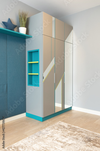 Wallpaper Mural A gray wardrobe with niche shelves, with a geometric pattern on the facade, with mirrors, in a teenager's room. Concept of modern interior details in an apartment or house. Vertical Torontodigital.ca