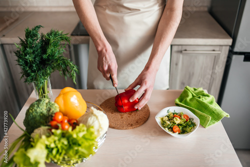 male hands chopping salad and onion, cooking healthy food in the kitchen.