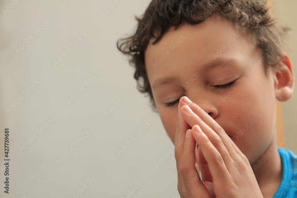 boy praying to God with hands together on white background stock photo boy praying to God with hands together on white background stock photo