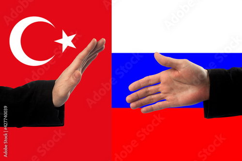 refusal to shake hands against the background of the Russian and Turkish flag. Strained relations between countries